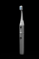 Electric ultrasonic toothbrush on black background.