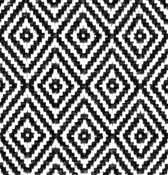 Rhombus - old ethnic canvas. Geometric ethnic pattern made with straw in black and white. knitting fabric pattern for background.