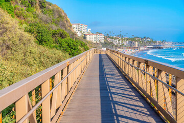 Narrow bridge with yellow railings near the mountain slope at the coastal area of San Clemente, CA