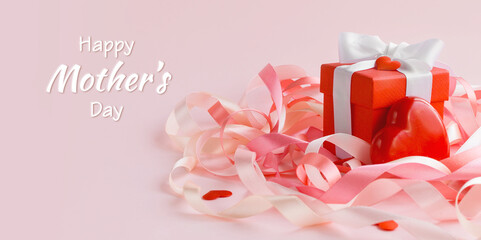 Happy Mother's Day or women's day. Valentine's day. White greeting card on a pink background with festive ribbons. Blurred focus. Greeting card