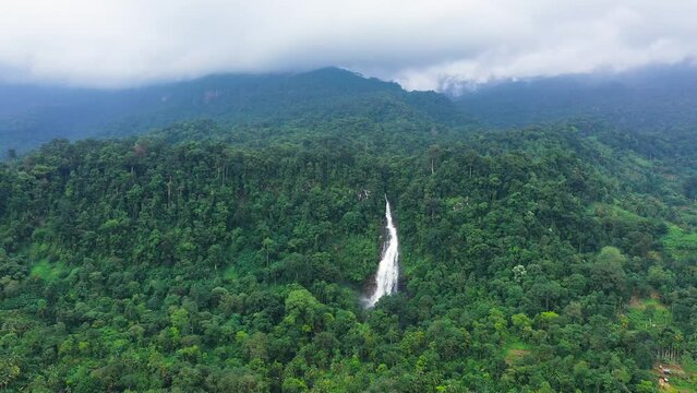 A beautiful waterfall in the mountains among the jungle. Mapalana Falls. Sri Lanka.