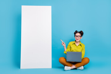 Full size photo of attractive cheerful lady direct finger empty space ui panel isolated on blue color background