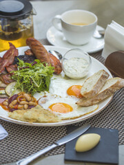 Fried Eggs with Bacon and Salad on Served Table, Concept food, Breakfast