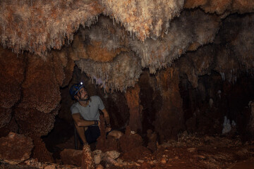 Young tourist in a miner helmet in the large Bellamar caves (Cuevas de Bellamar), Cuba