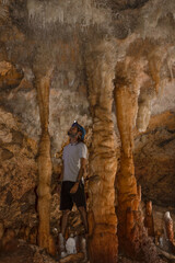 Young tourist in a miner helmet in the large Bellamar caves (Cuevas de Bellamar), Cuba
