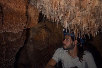 Young tourist in a miner helmet in the large Bellamar caves (Cuevas de Bellamar), Cuba