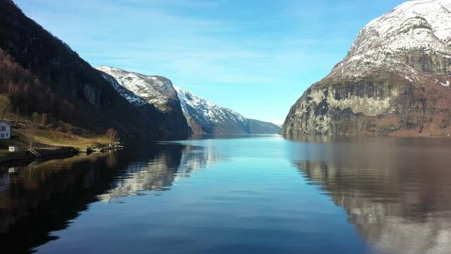 Beautiful winter morning in Aurlandsfjord Norway -Aerial close to sea surface outside undredal between Flam and Gudvangen