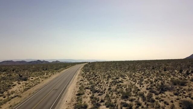 1 million $ aerial view flight drone footage of a empty road, no clouds in the sky and mountin in the desert in Coachella Valley usa 2018. Cinematic nature view from above by Philipp Marnitz