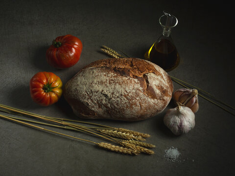 Bread near tomatoes and garlic