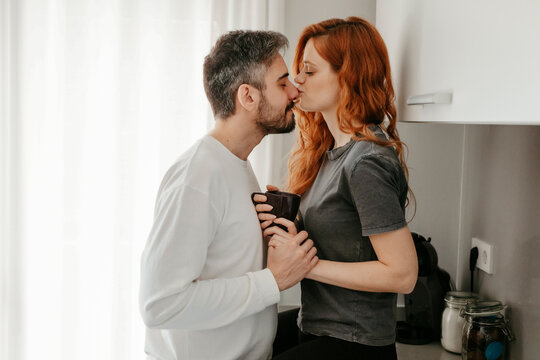 Loving couple caressing in kitchen