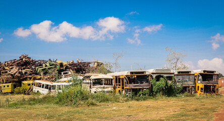 Fototapeta premium Rusted and Crushed Buses on the Tank Graveyard in Asmara, Eritrea