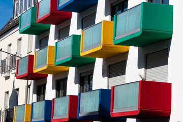 Facade of a residential building with multi colored balconies.