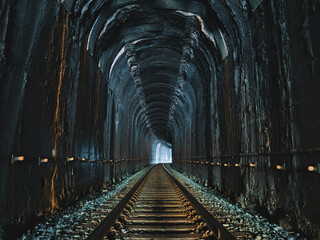 Old and rustic railroad inside a tunnel