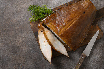 Fresh smoked halibut slices cutted on brown background. View from above. Healthy omega 3...