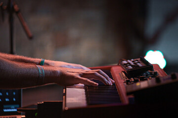 Selective focus shot of a man playing on synthesizer