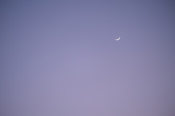 evening purple sky background and tiny crescent moon