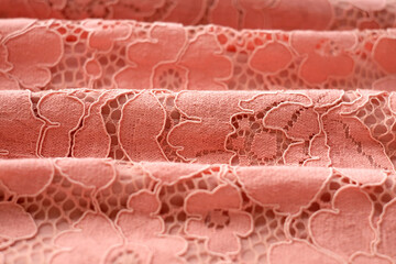 Pink lace textile fabric, abstract background, close-up