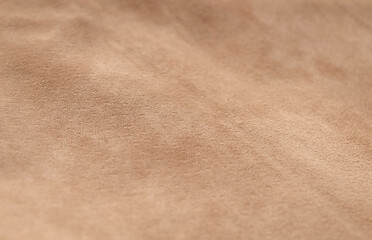 Light suede leather beige matte background top view