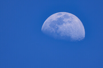 Moon fading in a blue sky