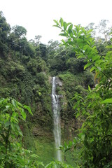 Beautiful waterfall in tropical rainforest, Indonesia waterfall in Cimahi. Green background wallpaper