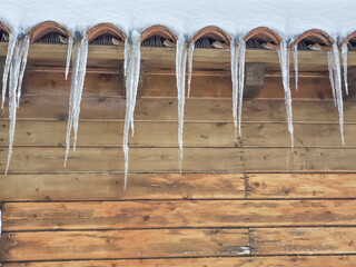 Icicles hanging from a snowy roof