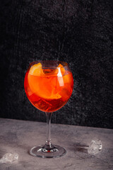 Glass of cold Aperol spritz cocktail.
