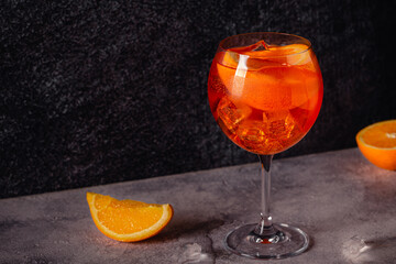 Glass of cold Aperol spritz cocktail.