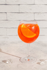Glass of cold Aperol spritz cocktail.
