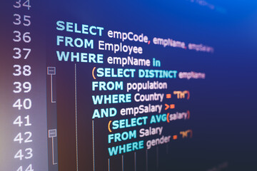 SQL (Structured Query Language) code on computer monitor. Example of SQL code to query data from a...