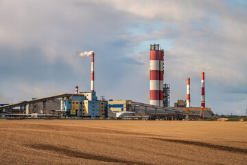 Fototapeta na wymiar panorama of industrial landscape environmental pollution waste of thermal power plant. Big pipes of chemical industry enterprise plant