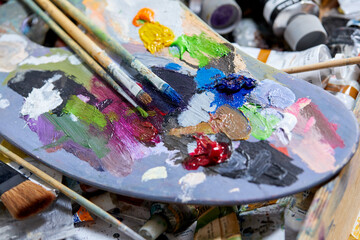 Tubes of oil paint and artist paint brushes