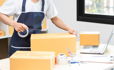 Fototapeta na wymiar Small business owner delivery service and working packing box, business owner working checking order to confirm before sending customer in post office, Shipment Online Sales.