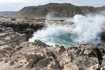 SEA WAVES BREAKING ON ROCKS 