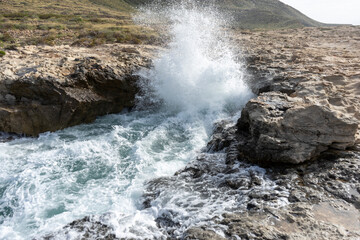 SEA WAVES BREAKING ON ROCKS 
