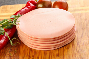 Sliced pork sausages stack over board