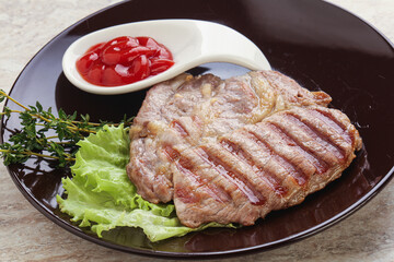 Grilled pork neck steak with ketchup