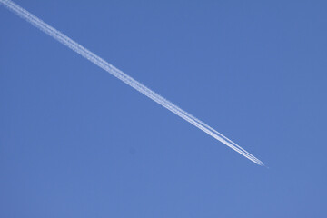 Low angle shot of vapor trails plane trail in the clear skies