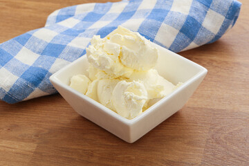 Italian soft mascarpone cheese in the bowl