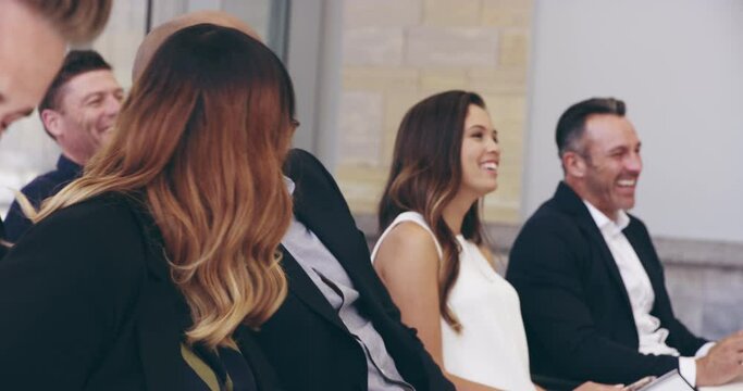 Hold on to your coffee because this is going to be funny. Group of diverse and different aged business people laughing, having fun, being happy during training workshop seminar in a convention center