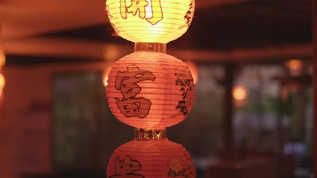 Typical, traditional chinese decoration with paper lamps and wooden roof. 4K. Slow motion.