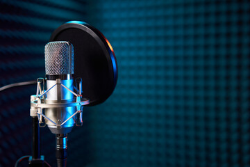 Studio chrome microphone on acoustic foam panel background,
