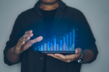 Concept of business technology, business people holding smartphone with show the graph of business on visual screen