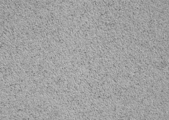 Abstract wall background. Grey plaster with mosaic pattern. Light surface with a chaotic loose pattern. Mosaic and granulated textured coating, texture, background