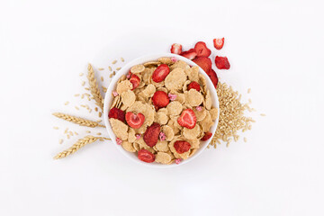 wheat spike next to bowl of dry strawberry corn flakes