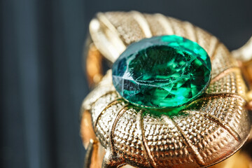 green natural gemstone, Gems or gems on shiny gold