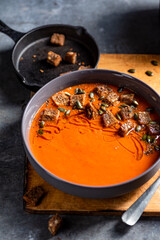 Roasted veggies cram soup with croutons, pumpkin seed and olive oil.