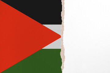 Half- ripped paper background in colors of national flag. Palestinian National Authority