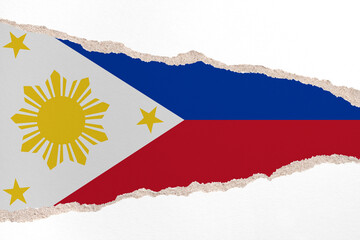 Ripped paper background in colors of national flag. Philippines