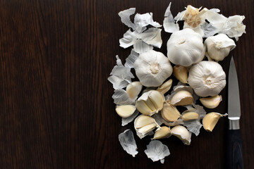 Garlic cloves on wood table background. Alternative medicine. Cooking preparation concept.