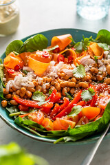 Vegan bowl with white bean, fresh spinach, carrot, red pepper, shallot, coriander and tomatoes.